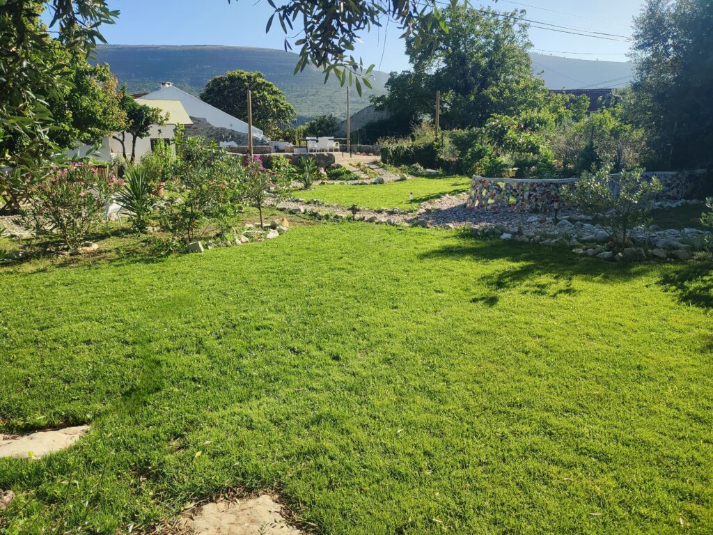 View of the garden and mountain range behind Vivenda Montanha, the ideal family holiday home in Portugal